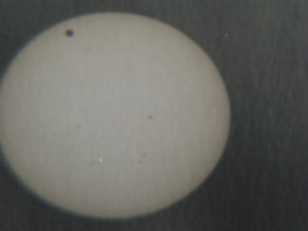 Venus' shadow clearly showing on the sun's disk.
