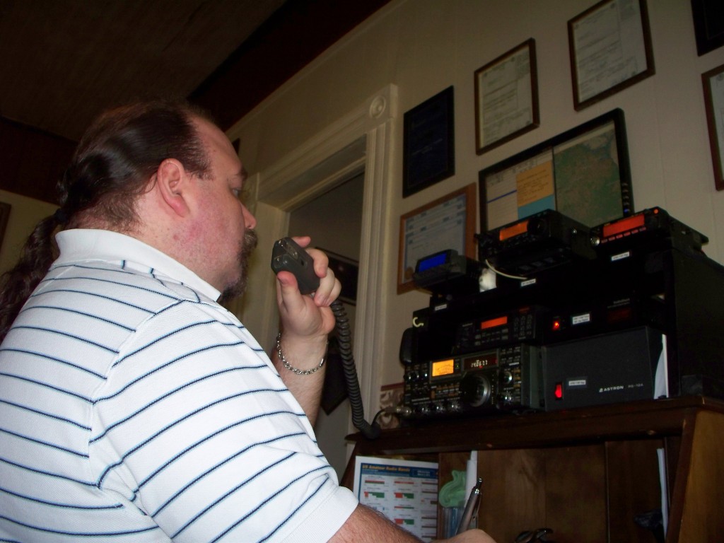 Geof using a radio in his shack.