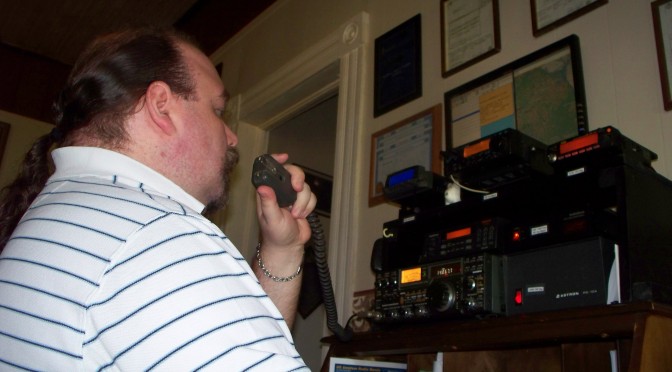 Geof using a radio in his shack.