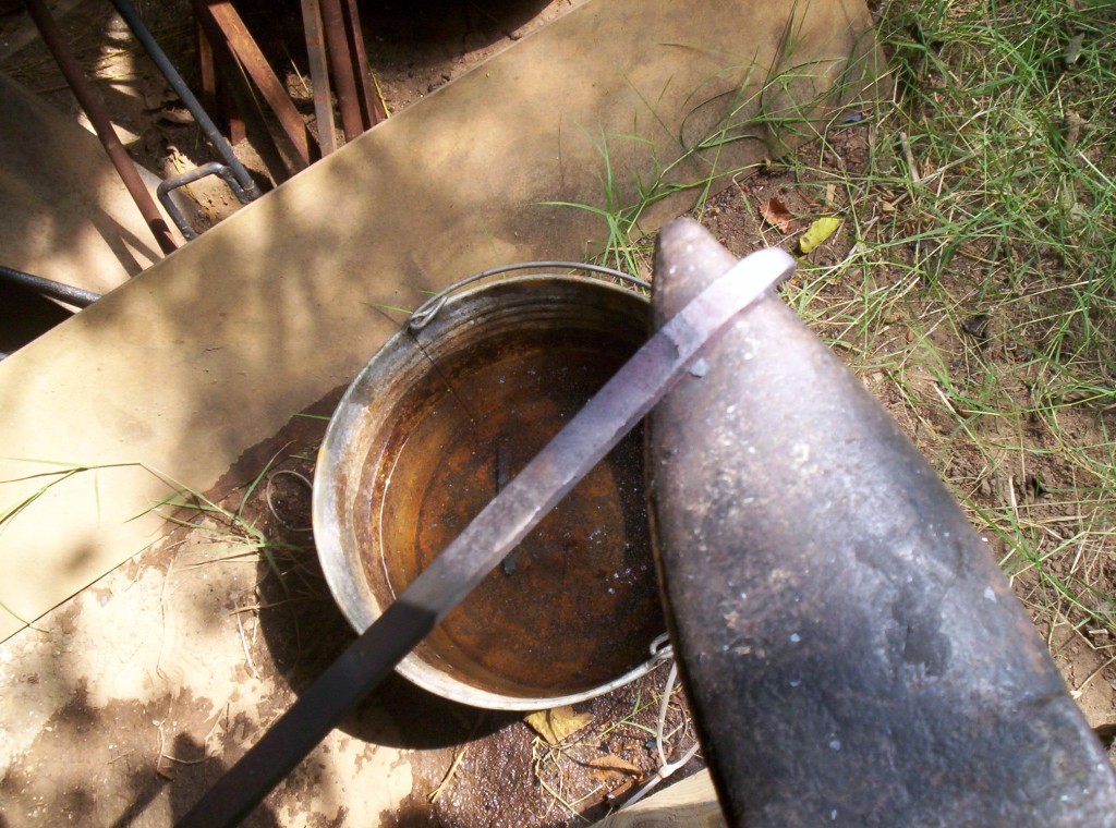 The stock is hammered around the horn of the anvil to form a curve in the end of the metal.