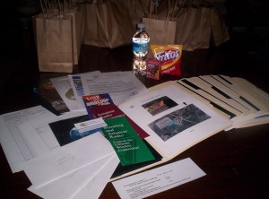 A display of the packet's each participant got including folders food water and handouts.