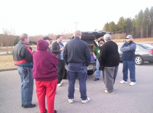 Volunteers standing in a circle waiting for instructions.