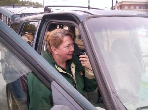 Barbara sitting in a truck talking on a radio.