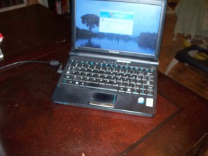A netbook sitting on the desk.