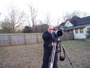 Geof aligning a telescope with a compass.