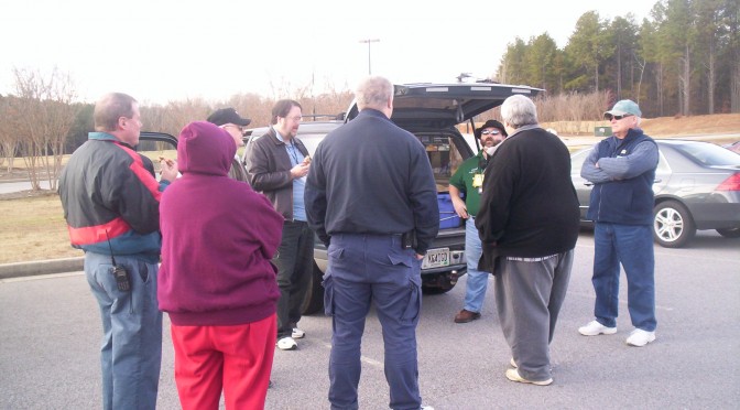 Volunteers standing in a circle waiting for instructions.