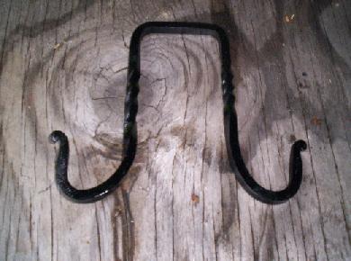 A double hook, left and right are curved hooks, the centre is square to rest on top of the ridgepole.