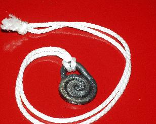 A metal spiral on a white cord.